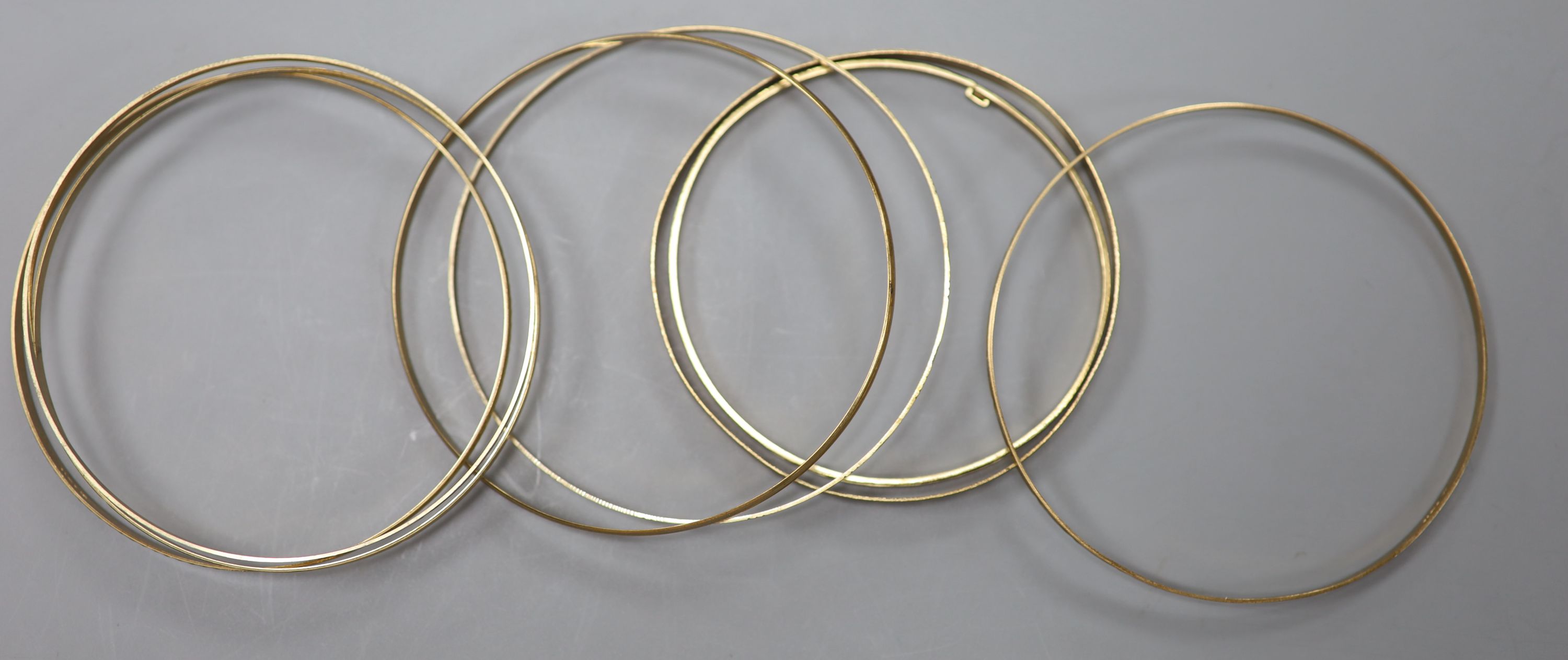 Eight assorted modern 9ct gold bangles